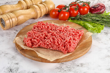 Raw minced beef meat on cutting board