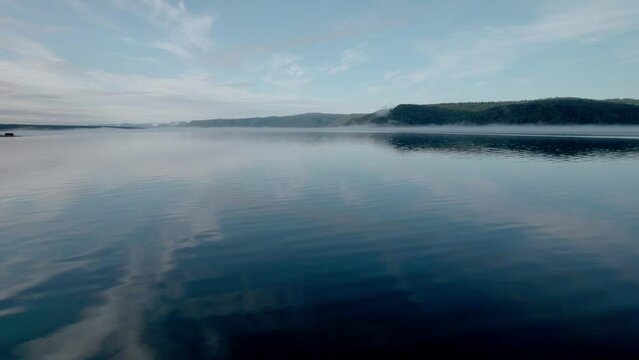 "Capture the breathtaking beauty of Lake Baikal and the Angara River from above in stunning aerial footage. Ships and boats glide through the crystal-clear waters, offering fantastic views.