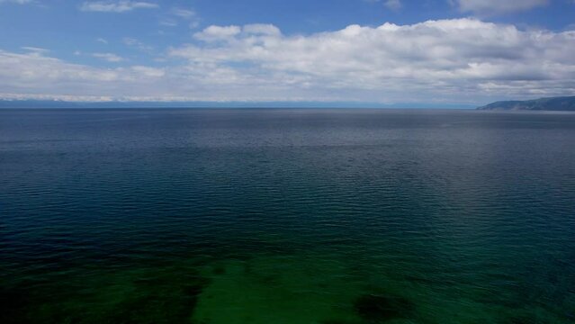 "Capture the breathtaking beauty of Lake Baikal and the Angara River from above in stunning aerial footage. Ships and boats glide through the crystal-clear waters, offering fantastic views.