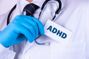Doctor, man put a card with the text ADHD in his pocket. Medical concept.