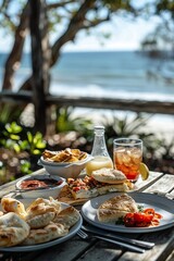 A casual Australian breakfast table with Vegemite spread on toast, a side of meat pies with tomato sauce, and grilled barramundi fish on a plate.