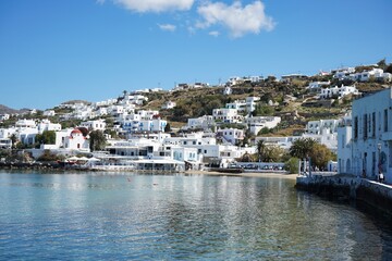 Fototapeta na wymiar Panoramic landscape of the coast and mountains of Mykonos from the harbor of the Old Town in Mykonos, Greece