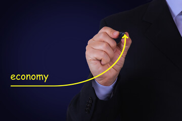 Businessman draw growing line symbolize growing ECONOMY. Concept oil crisis and financial meltdown.