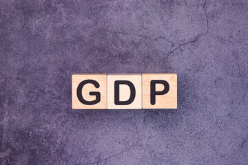GDP, Gross Domestic Product concept, cube wooden block with alphabet combine abbreviation GDP,...