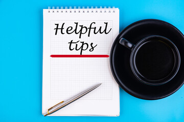 Helpful Tips - handwriting on a notebook with pen and a cup of coffee