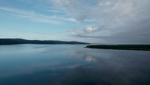 "Capture the breathtaking beauty of Lake Baikal and the Angara River from above in stunning aerial footage. Ships and boats glide through the crystal-clear waters, offering fantastic views.
