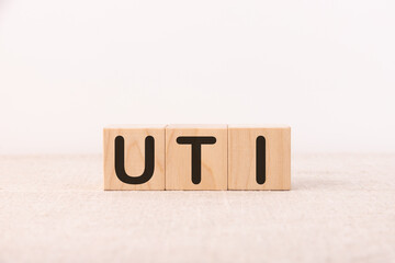 UTI - acronym from wooden blocks with letters, abbreviation UTI urinary tract infection.