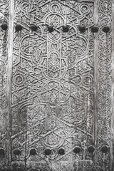 An ancient wooden door with patterns and ornaments in the ancient city of Khiva in Uzbekistan, wood carving