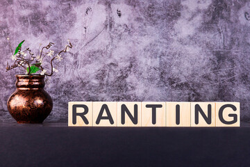 RANTING word made with wooden building blocks on a grey background