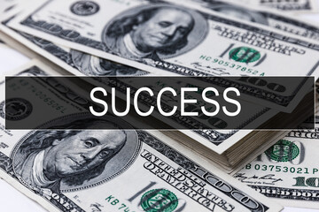 Text SUCCESS is written on the background of American banknotes. Business concept.