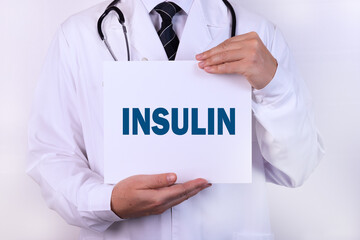 A doctor in medical clothing is holding a sign with a diagnosis in front of him, text INSULIN...