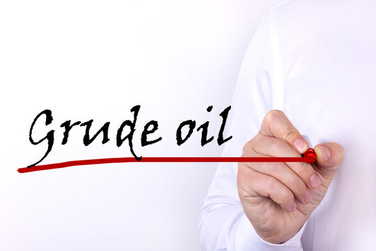 GRUDE OIL text written by businessman hand, marker on a light background. Business concept.