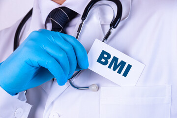 A doctor in medical clothing puts a card with the text BMI. Medical concept.
