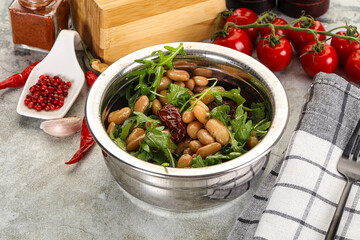 White canned beans with arugula and dry tomatoes