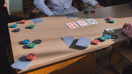 Obraz premium High school students play poker in their free time.