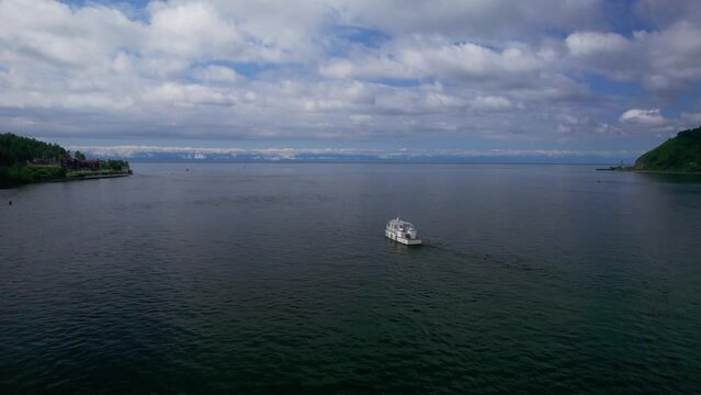 "Capture the breathtaking beauty of Lake Baikal and the Angara River from above in stunning aerial footage. Ships and boats glide through the crystal-clear waters, offering fantastic views.