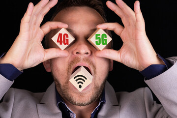 Business concept of choosing and comparing 4G and 5G communication standards. The businessman holds...