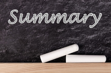 Summary text on blackboard with two pieces of chalk.