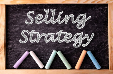 Chalkboard and color chalks with text Selling Strategy