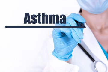ASTHMA text written by a doctor hand with a stethoscope. medical concept.