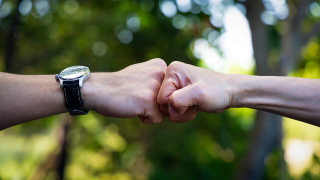 Deal of teamwork with the Man hand a fist bump commit as get together in the office.