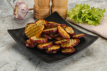 Baked red batat slices with herbs