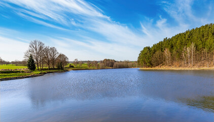 Spring lake view with blue sky. - obrazy, fototapety, plakaty