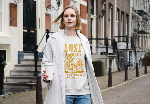 Mockup of woman in customizable top and jacket with coffee