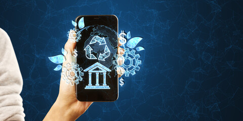 Close up of woman hand holding cellphone with creative esg hologram on polygonal blue background...