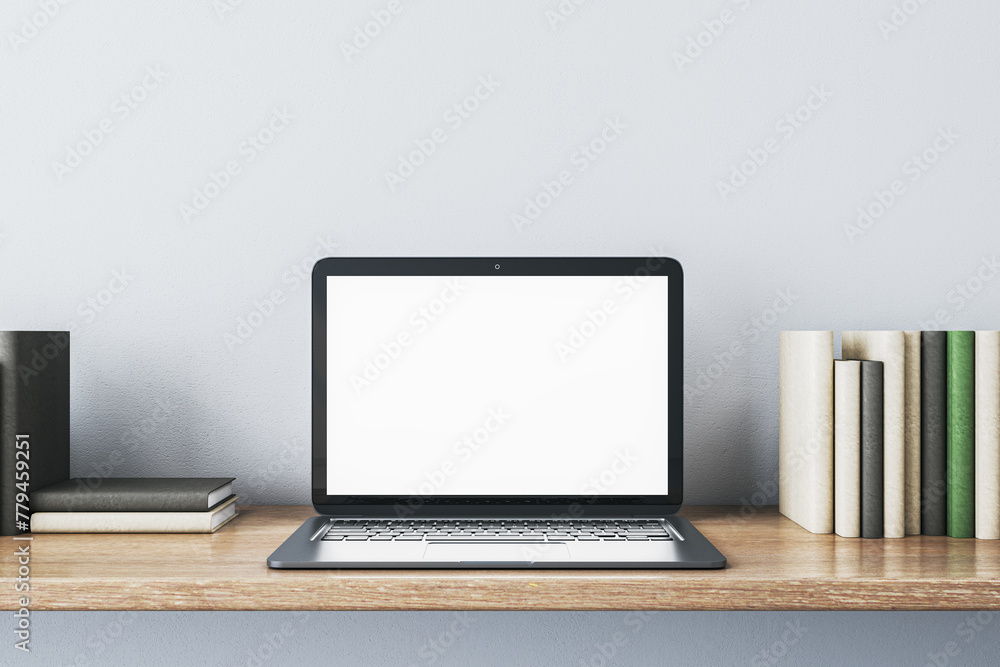 Poster close up of creative wooden designer desk with books and empty white mock up laptop screen on white 