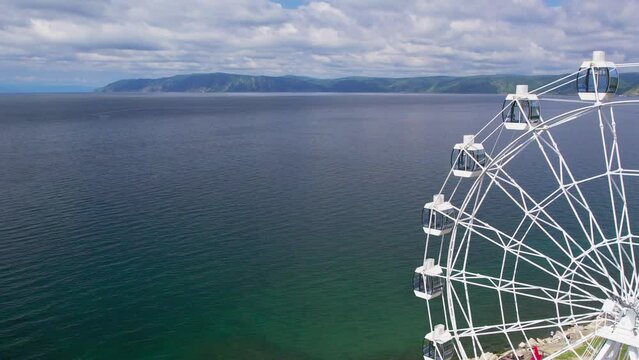 "Capture the breathtaking beauty of Lake Baikal and the Angara River from above in stunning aerial footage. Ships and boats glide through the crystal-clear waters, offering fantastic views.