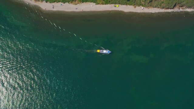 "Capture the breathtaking beauty of Lake Baikal and the Angara River from above in stunning aerial footage. Ships and boats glide through the crystal-clear waters, offering fantastic views.