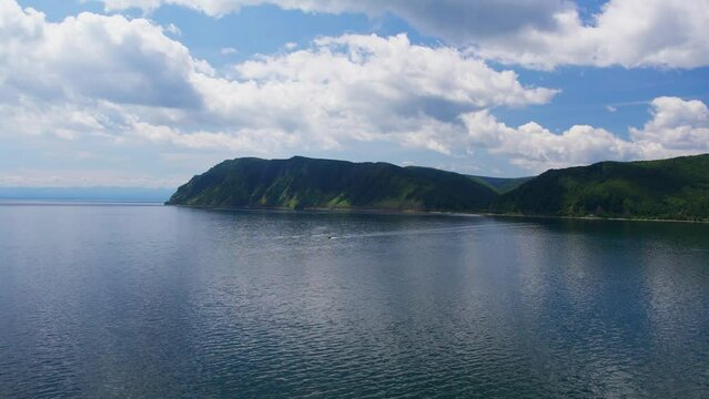"Capture the breathtaking beauty of Lake Baikal and the Angara River from above in stunning aerial footage. Ships and boats glide through the crystal-clear waters, offering fantastic views.