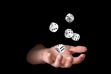 Man throwing white dice on black background, closeup