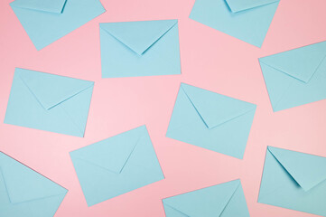 Top view of light blue envelopes on pink background. Post flat lay. Copy space.