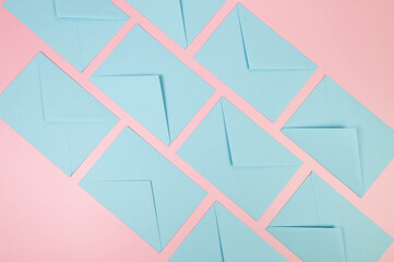 Top view of light blue envelopes on pink background. Post flat lay. Copy space.