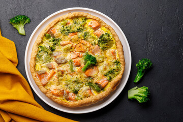 Homemade pie with salmon and broccoli