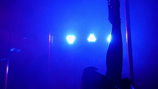 Slender legs of pole dancer in high heels, close-up. Close-up of stripper shoes in the club. Pole dance.