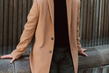 Beige brown men's coat, pants and black turtleneck. Classic street outerwear. Fashion details