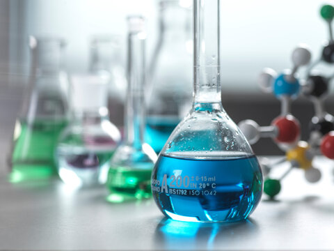 Blue chemical sample in flask at laboratory