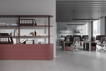 Bookcase with folders in maroon and gray hot desk office interior