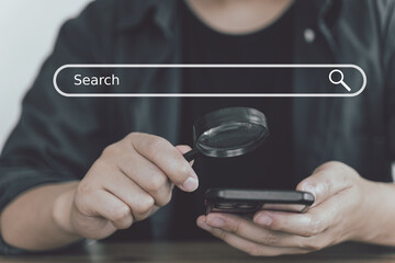 Search engine tool concept, business people holding magnifying and smartphone, Data finding on...