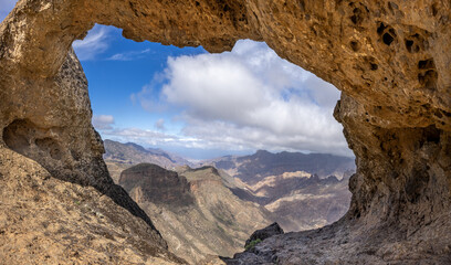 Looking through the rock formation Ventana del Bentayga (Window to Bentayga) to the west to the mountain landscape of central Canary island.