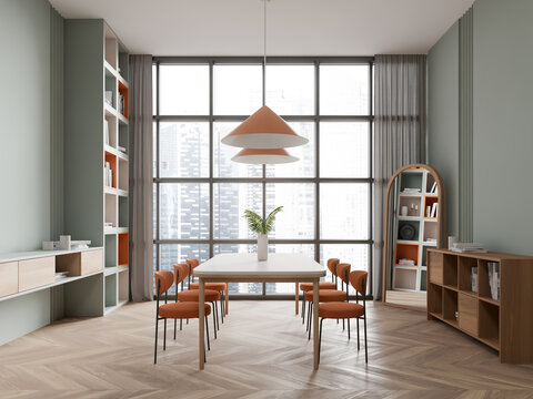 Green dining room interior with bookcase