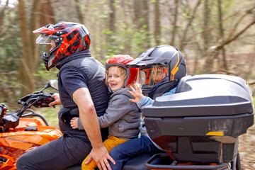 Children, riding on a buggy wheel with father, fast fourwheeler © Tomsickova