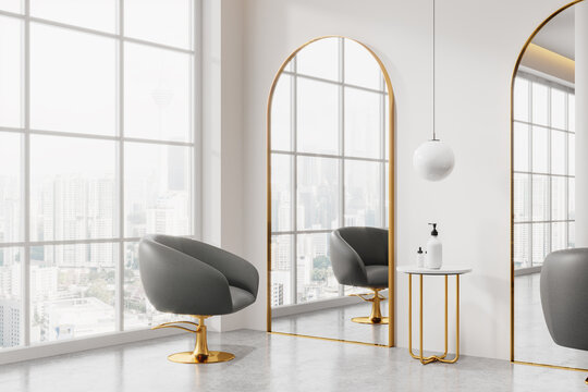 White beauty salon interior with armchairs, cosmetics on table near window