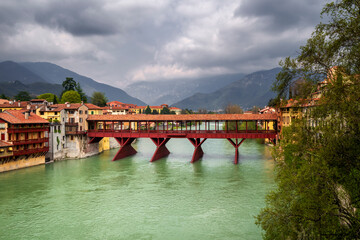 Antique wooden covered red bridge over a river. Ponte Vecchio or Ponte degli Alpini over Brenta...