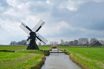 Silhouette of the Terpzigt windmill near Marssum in Friesland The Netherlands is the smallest...