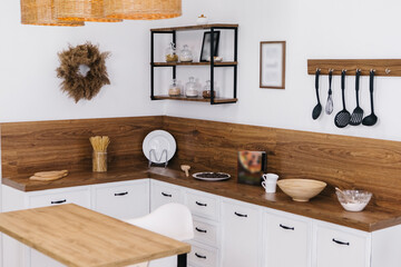 Close up contemporary kitchen with island, supplies equipment, table top, spice jars with...