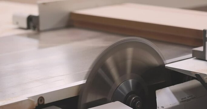 Circular saw close-up. Work in a furniture factory